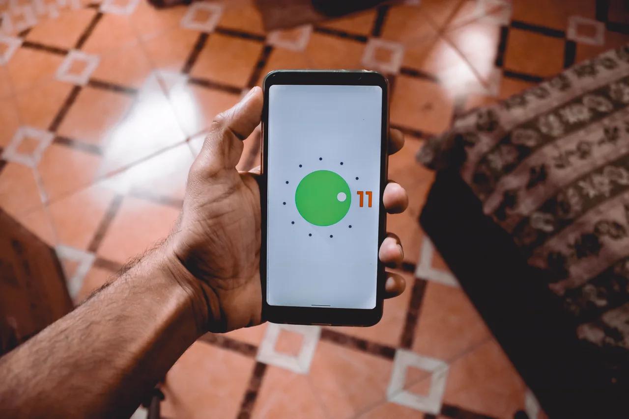 A man holding his phone at home